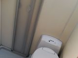 a toilet and a shower in a small bathroom