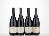 three bottles of red wine sitting on top of a table