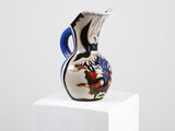 a glass vase sitting on top of a white pedestal