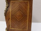 an image of a small wooden cabinet with a marble top