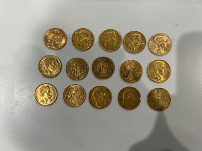 some of the gold coins have been placed on a white surface