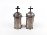 pair of silver salt and pepper shakers with crosses on top