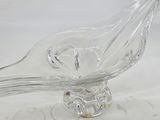 a glass bird that is sitting on top of a glass bowl