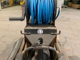 a blue hose on top of a pallet in a warehouse
