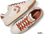 two pairs of white and red sneakers with brown laces on them