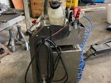 a machine that is sitting on a cart in a garage