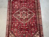 a red rug with a diamond design on it