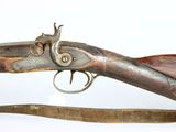 an old gun with a wooden handle on a white surface