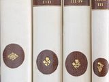 several books are lined up in a row on a shelf