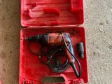 a red tool box with tools in it and a pair of brown shoes