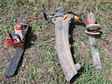 many tools that are laying on the ground in the grass