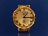 an image of a gold watch with roman numerals on a blue background