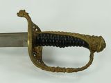 a close up of a sword on a white surface