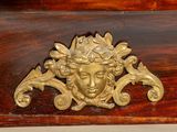 a gold head on a wooden table with a gold handle