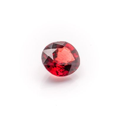 a red garnet stone on a white background