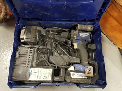 a blue box with tools in it sitting on a table