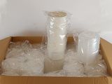 a cardboard box filled with plastic cups and a cup holder