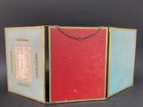 two red and blue books with gold chains on a black background