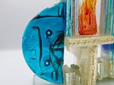 a glass vase with flowers inside of it on a stand