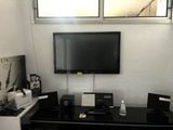 a black desk with a television on top of it