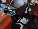 a tractor with a wheel and a bucket on the back of it