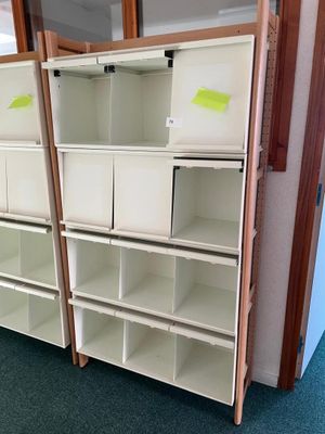 two shelves with bins on them in a room