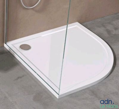 a white shower with a glass door and a shower head