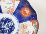 a blue and white plate with a picture of a dragon on it