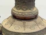 a large metal vase that is sitting on a table