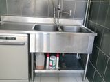 a stainless steel sink and dishwasher in a small kitchen