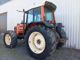 a tractor that is parked in front of a building