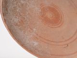 a brown plate with a circular design on it
