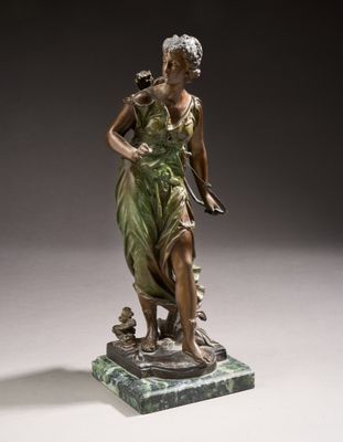 an antique bronze statue of a woman holding a bird on a marble base