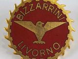an image of a red and gold pin with an eagle on it