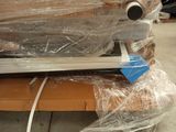a couch that is wrapped in plastic and sitting on the floor