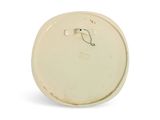 a white plate with a handle on it on a white surface