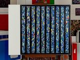 a painting on a easel in a room with many different colored boxes