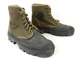 pair of military boots on a white surface with a white background