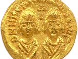 a close up of a gold coin on a white surface