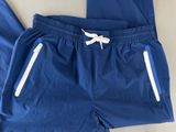 a close up of a pair of blue pants with white zippers