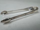 pair of silverware spoons on a white surface