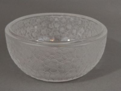 a glass bowl that has a flower design on it