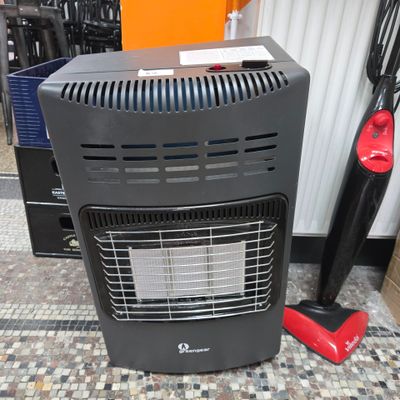 a black heater sitting on the floor next to a red vacuum