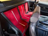 a red seat in the back of a car with black seats