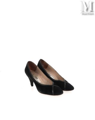Les chaussures noires de la femme reposent sur la surface blanche.