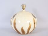 a white and gold vase on a white surface