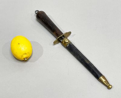 a knife and a lemon on a white surface