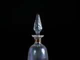 a glass bottle with a clear top on a table
