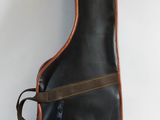 an image of a guitar case sitting on top of a white surface