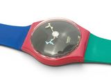 a colorful wrist watch on a white surface with a white background